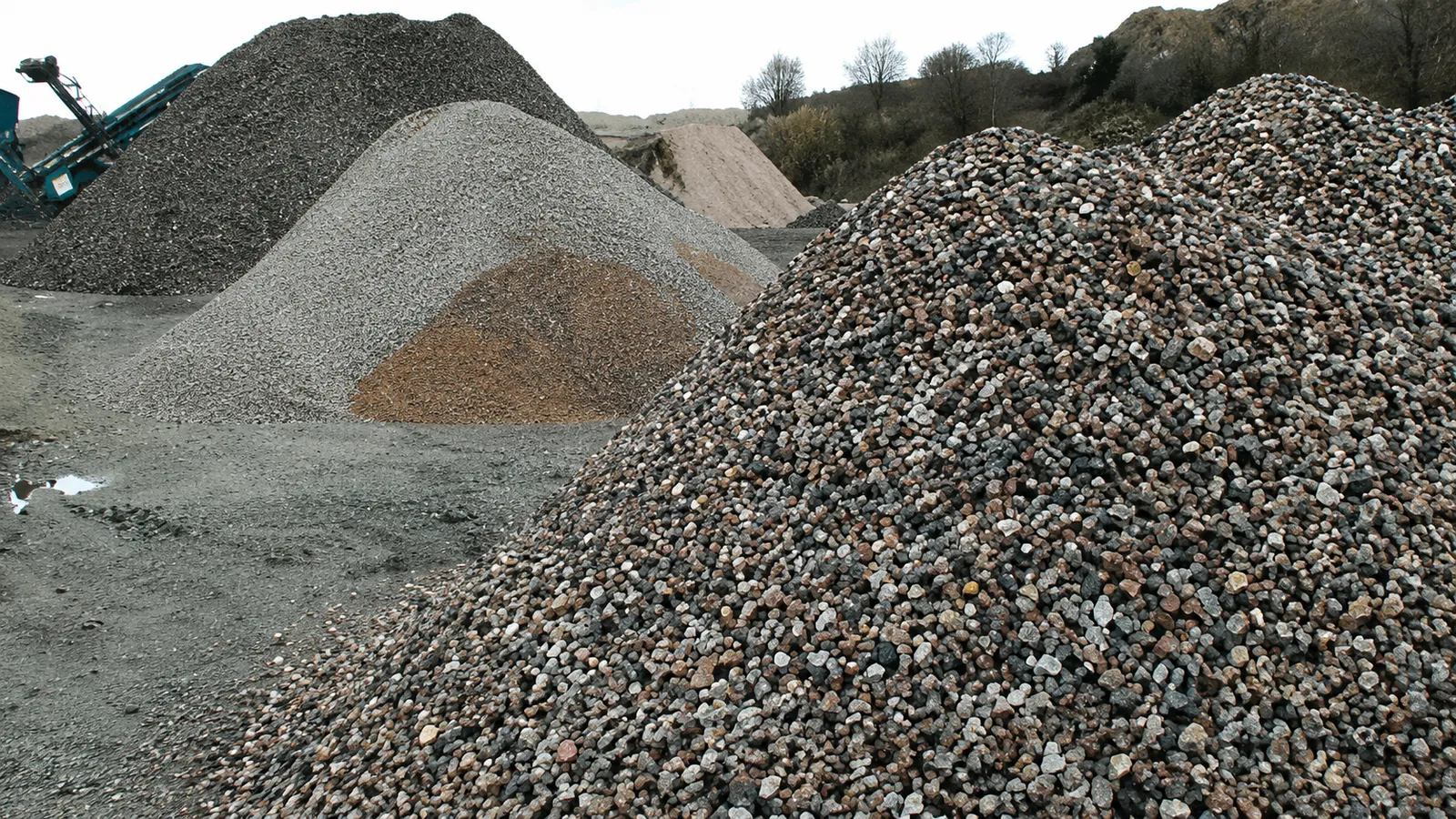 Piles of construction aggregate and sand